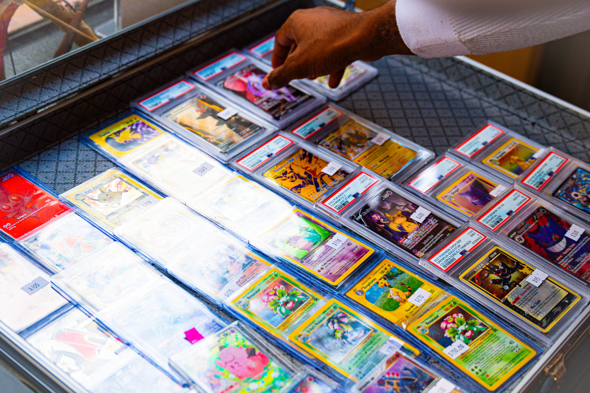 Graded and raw cards in the display case at Neo Collector